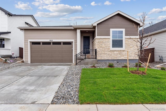 19110 E 96th Pl, Commerce City, CO 80022 - view of front of house featuring an attached garage, concrete driveway, stone siding, and a front yard
