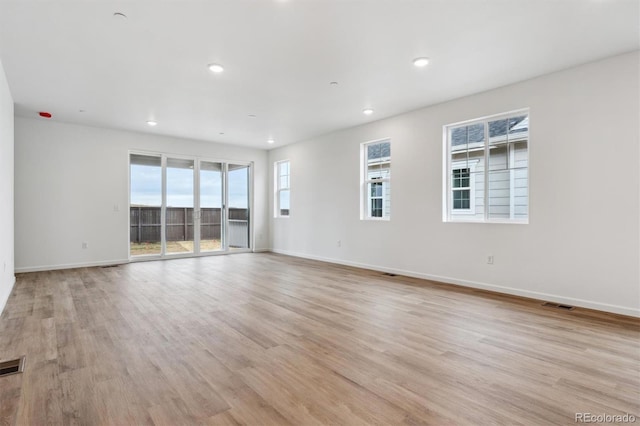 19110 E 96th Pl, Commerce City, CO 80022 - unfurnished room featuring healthy amount of natural light, baseboards, light wood-style floors, and recessed lighting