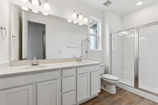 19110 E 96th Pl, Commerce City, CO 80022 - full bath with a stall shower, toilet, wood finished floors, and double vanity