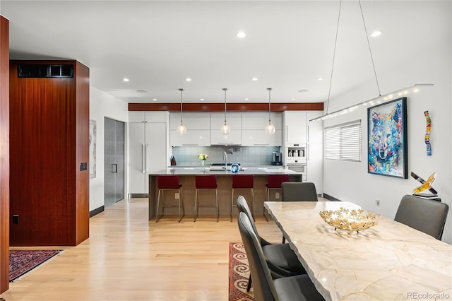 dining space with light hardwood / wood-style flooring