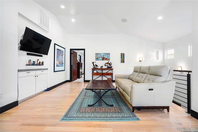 living room featuring light hardwood / wood-style floors and lofted ceiling