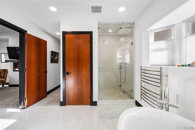 bathroom featuring a shower with shower door