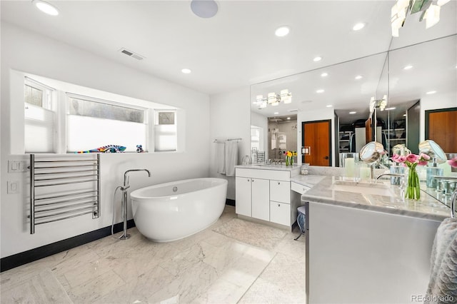 bathroom with vanity and a bathtub