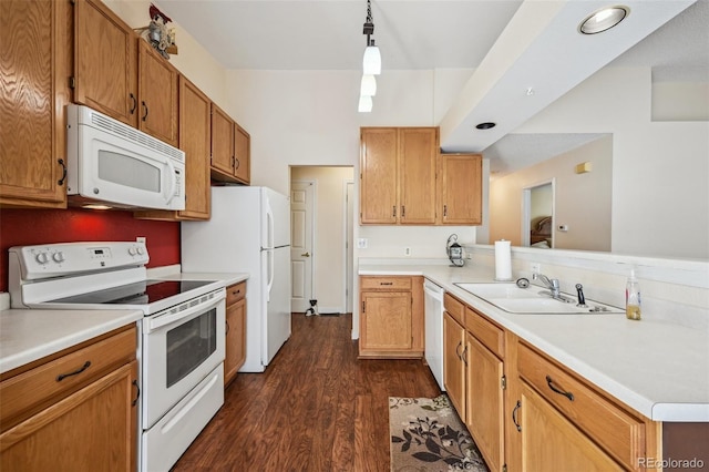 11565 Decatur St Unit 7D, Denver, CO 80234 - kitchen featuring white appliances, a sink, dark wood-style floors, a peninsula, and light countertops