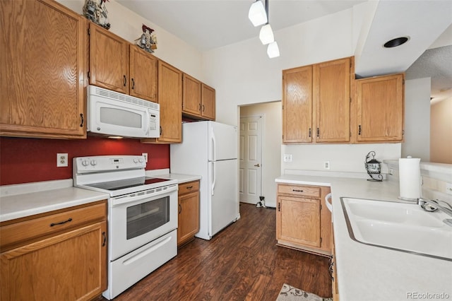 11565 Decatur St Unit 7D, Denver, CO 80234 - kitchen with white appliances, a sink, dark wood-style flooring, light countertops, and brown cabinets