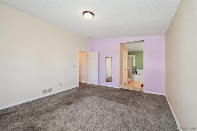 11565 Decatur St Unit 7D, Denver, CO 80234 - unfurnished bedroom featuring carpet floors, baseboards, a textured ceiling, and ensuite bath