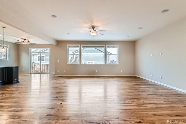 unfurnished living room with ceiling fan and hardwood / wood-style flooring