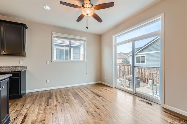 interior space with a healthy amount of sunlight, ceiling fan, and light wood-type flooring