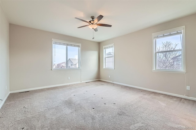 empty room featuring ceiling fan and carpet floors