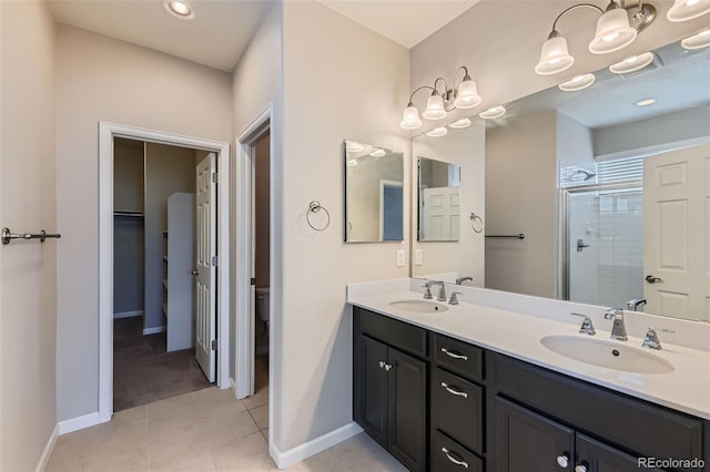 bathroom featuring vanity, an enclosed shower, and tile patterned floors