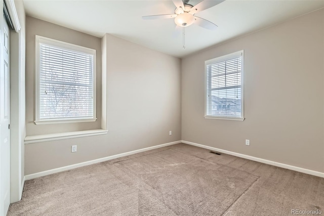 unfurnished room with ceiling fan and light carpet