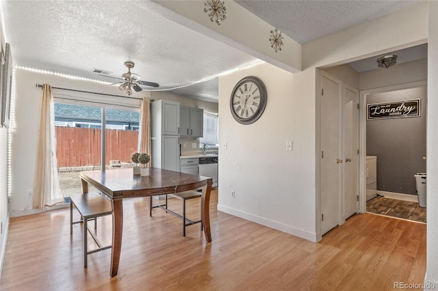 15627 E 51st Dr, Denver, CO 80239 - dining space featuring baseboards, visible vents, a ceiling fan, a textured ceiling, and light wood-type flooring