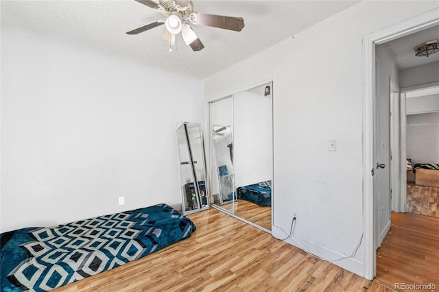 15627 E 51st Dr, Denver, CO 80239 - bedroom with a closet, ceiling fan, a textured ceiling, and wood finished floors