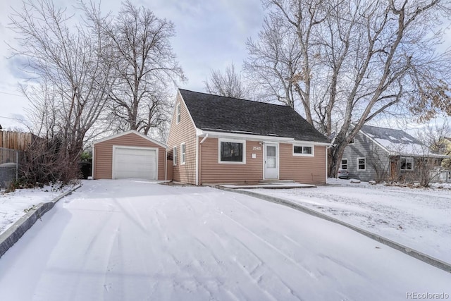 view of front of property with a garage and an outbuilding