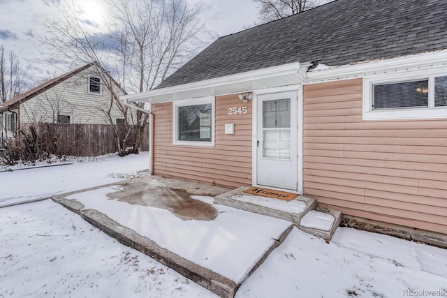 view of snow covered property entrance