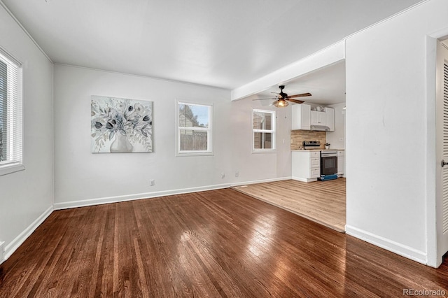 unfurnished living room with beam ceiling, wood-type flooring, and ceiling fan