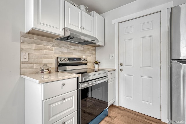 kitchen featuring light hardwood / wood-style flooring, backsplash, stainless steel appliances, and white cabinetry