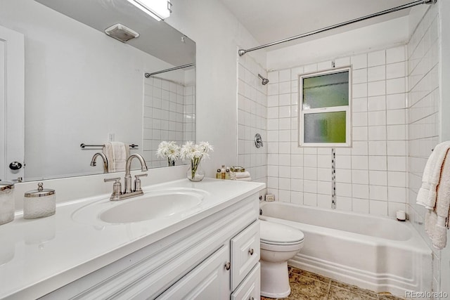 full bathroom with toilet, tiled shower / bath, and vanity