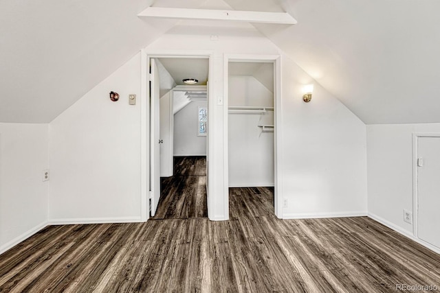 bonus room with dark hardwood / wood-style floors and vaulted ceiling with beams