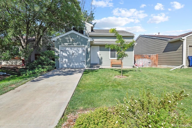 view of front of home featuring concrete driveway, an attached garage, fence, and a front yard