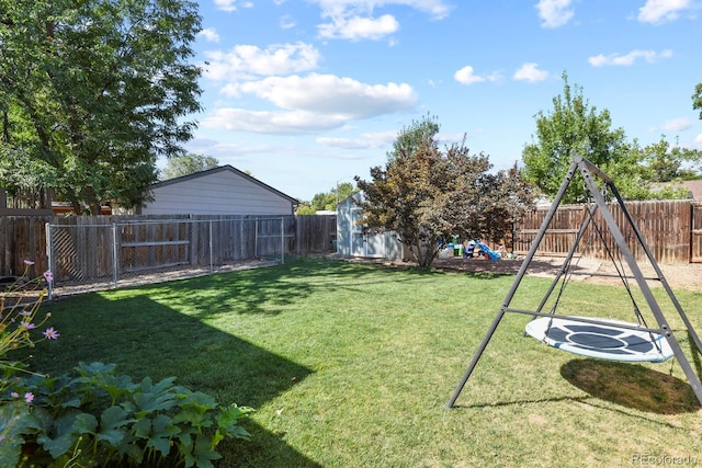 view of yard with a playground and a fenced backyard