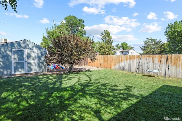 view of yard featuring an outbuilding, a storage shed, and a fenced backyard