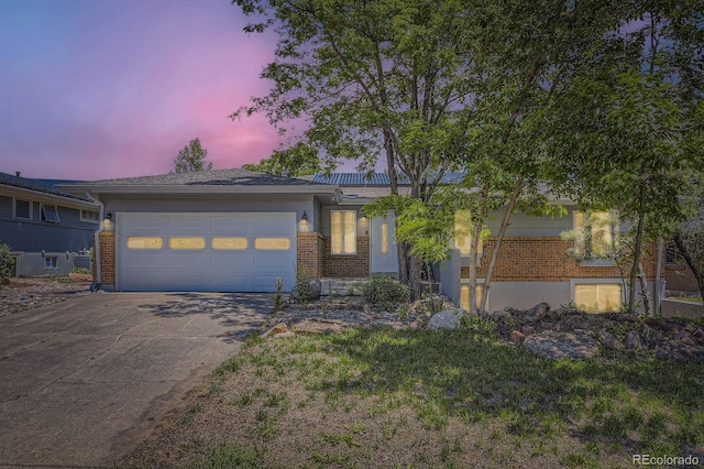 540 Ithaca Dr, Boulder, CO 80305 - view of front of home with brick siding, driveway, and a garage