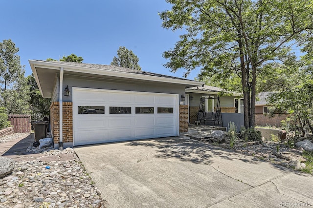 540 Ithaca Dr, Boulder, CO 80305 - view of front of home featuring brick siding, driveway, and a garage