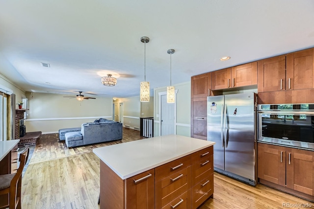 540 Ithaca Dr, Boulder, CO 80305 - kitchen with stainless steel appliances, ceiling fan, light wood-type flooring, brown cabinetry, and recessed lighting
