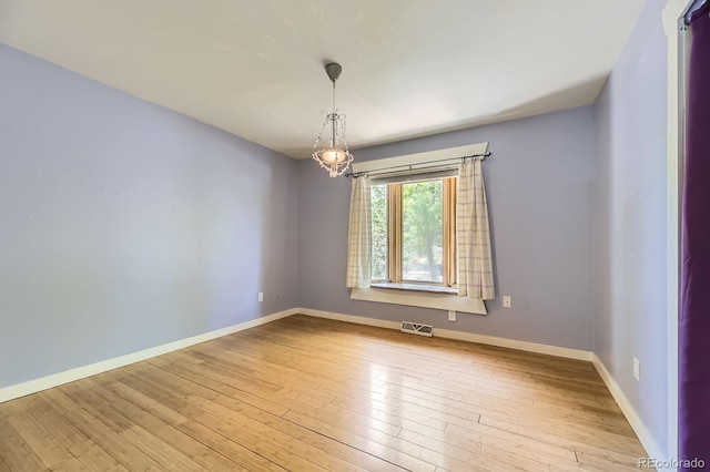 540 Ithaca Dr, Boulder, CO 80305 - unfurnished room featuring hardwood / wood-style flooring and a chandelier
