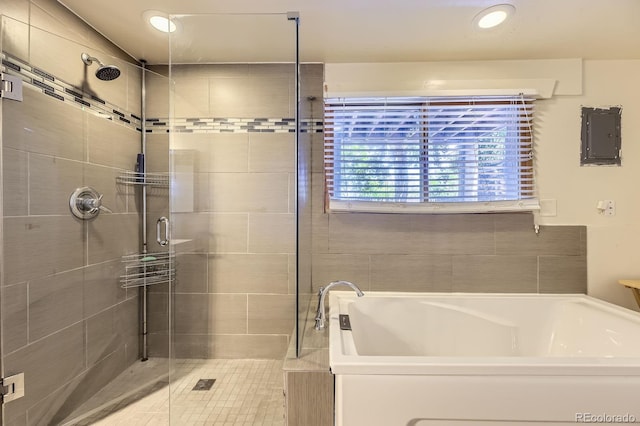 540 Ithaca Dr, Boulder, CO 80305 - bathroom with electric panel, a bath, a shower stall, and recessed lighting