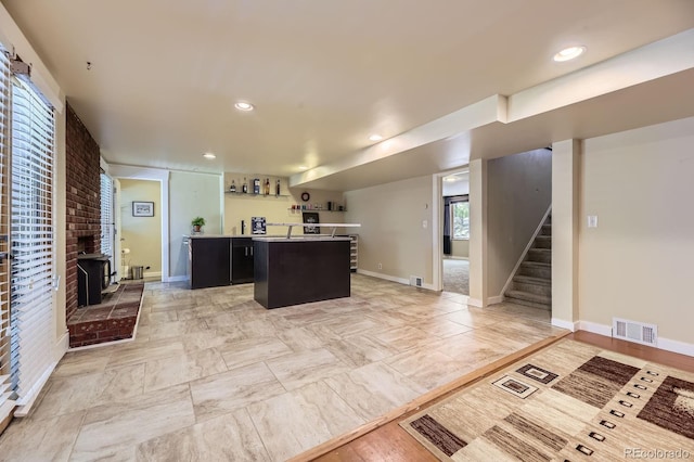 540 Ithaca Dr, Boulder, CO 80305 - kitchen featuring a kitchen island, recessed lighting, a fireplace, and dark cabinetry