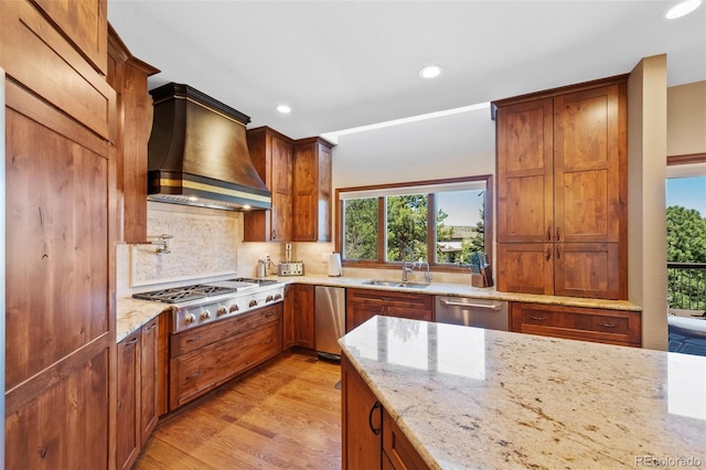 kitchen featuring a sink, stainless steel appliances, tasteful backsplash, recessed lighting, and custom exhaust hood