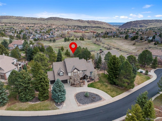 birds eye view of property with a mountain view and a residential view