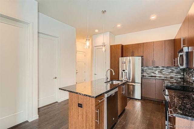 336 E 1st Ave Unit 200, Denver, CO 80203 - kitchen with appliances with stainless steel finishes, dark wood finished floors, dark stone countertops, and recessed lighting