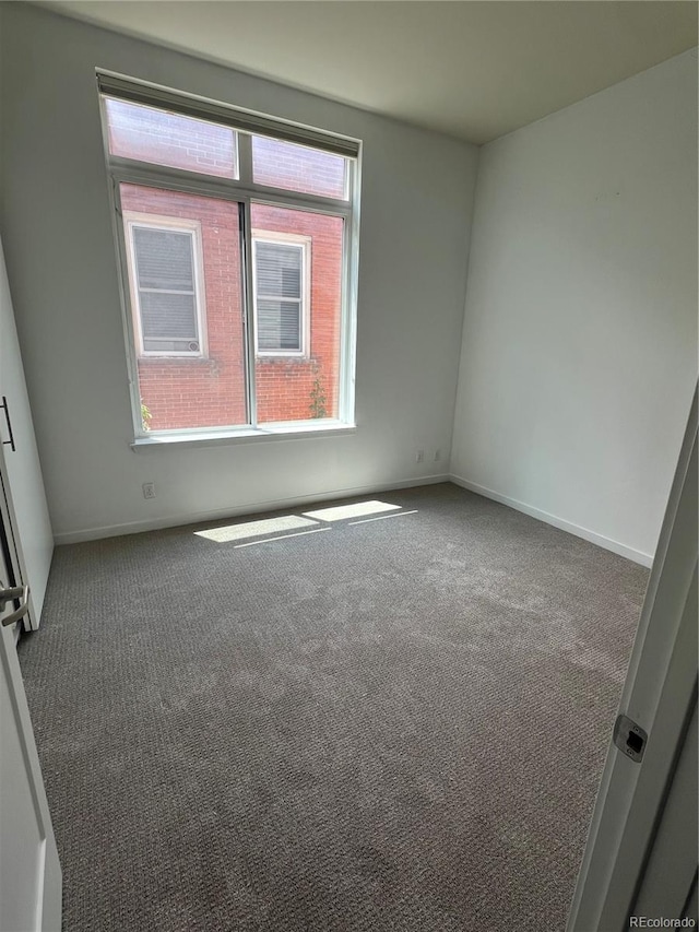 336 E 1st Ave Unit 200, Denver, CO 80203 - carpeted spare room featuring baseboards