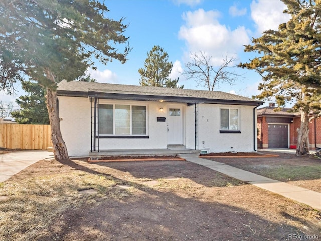 bungalow-style house featuring fence