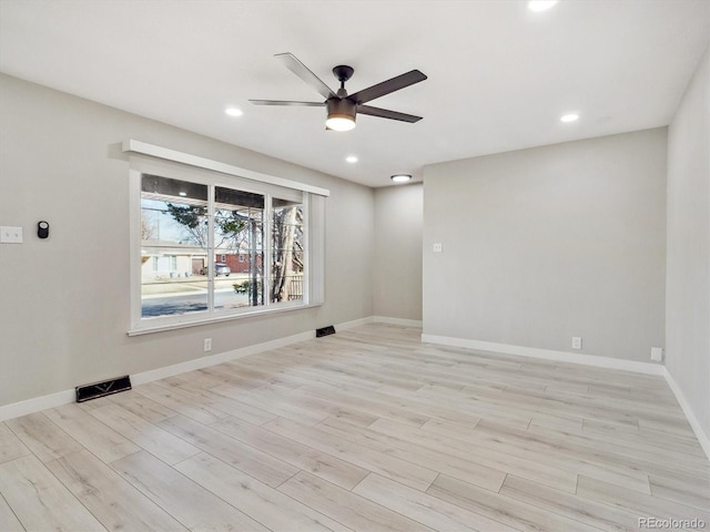 empty room with ceiling fan, recessed lighting, baseboards, wood finished floors, and visible vents