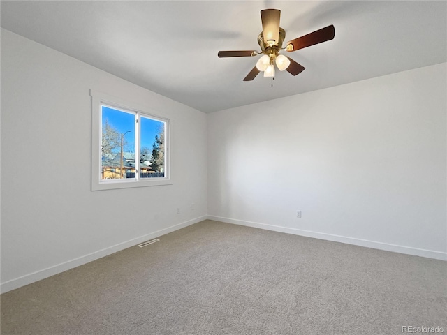 carpeted spare room with ceiling fan