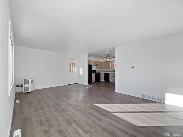 unfurnished living room featuring light hardwood / wood-style floors and ceiling fan