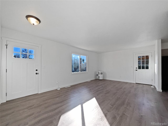 entrance foyer with dark hardwood / wood-style floors