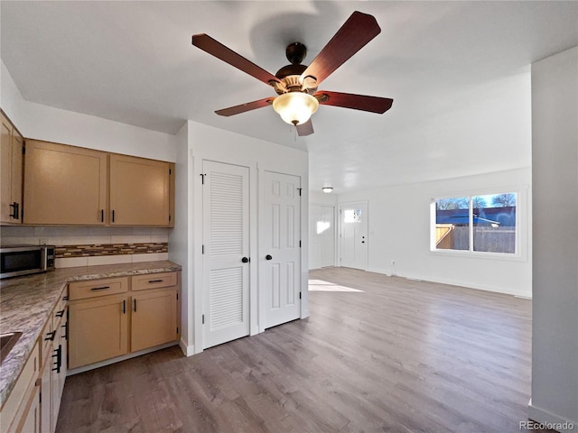 kitchen with light hardwood / wood-style floors, light brown cabinets, decorative backsplash, and ceiling fan