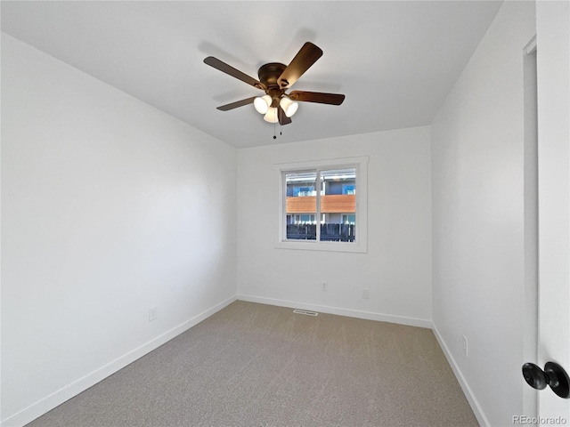 carpeted spare room featuring ceiling fan