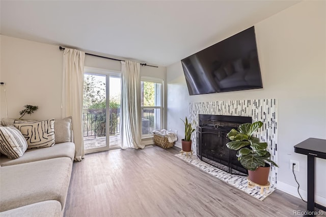 8450 Decatur St Unit 97, Westminster, CO 80031 - living area featuring wood finished floors and a fireplace with flush hearth