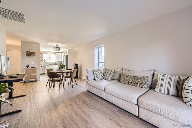 8450 Decatur St Unit 97, Westminster, CO 80031 - living area with light wood-style flooring and baseboards