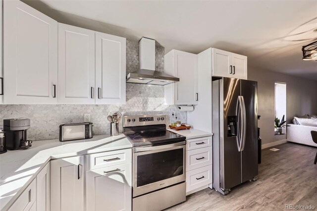 8450 Decatur St Unit 97, Westminster, CO 80031 - kitchen with stainless steel appliances, wall chimney exhaust hood, light countertops, backsplash, and white cabinets