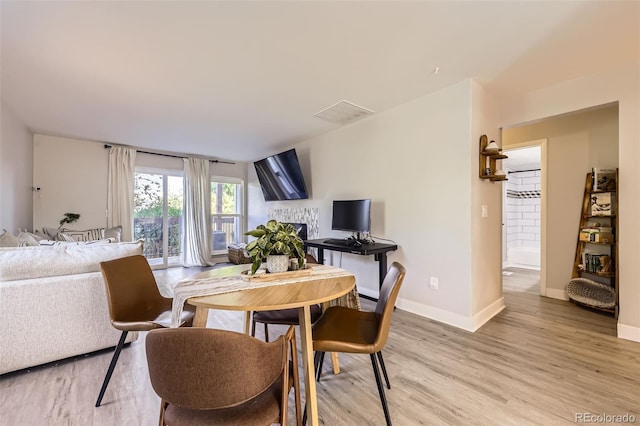 8450 Decatur St Unit 97, Westminster, CO 80031 - dining room featuring light wood finished floors and a fireplace
