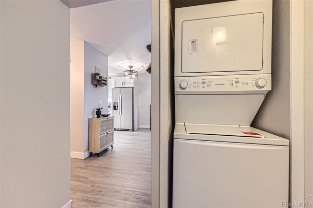 8450 Decatur St Unit 97, Westminster, CO 80031 - laundry room featuring stacked washer and clothes dryer and light wood-style floors