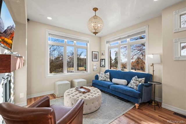 living room featuring an inviting chandelier and hardwood / wood-style flooring