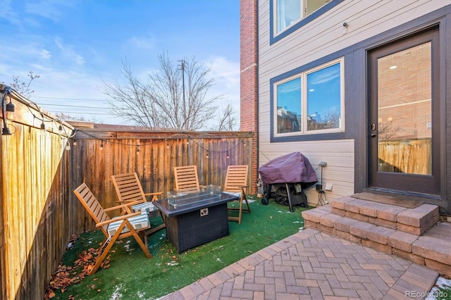 view of patio / terrace with a fire pit and area for grilling